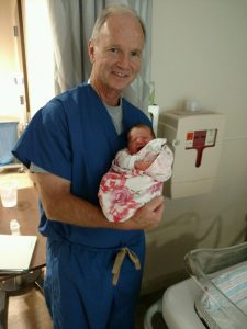Dr. Sparks holding newborn